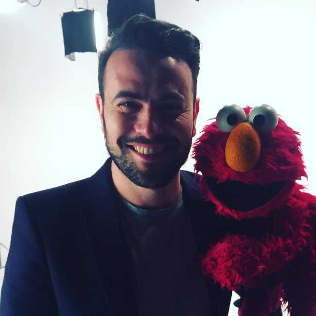 Ben Winston as seen smiling with Elmo in 2016