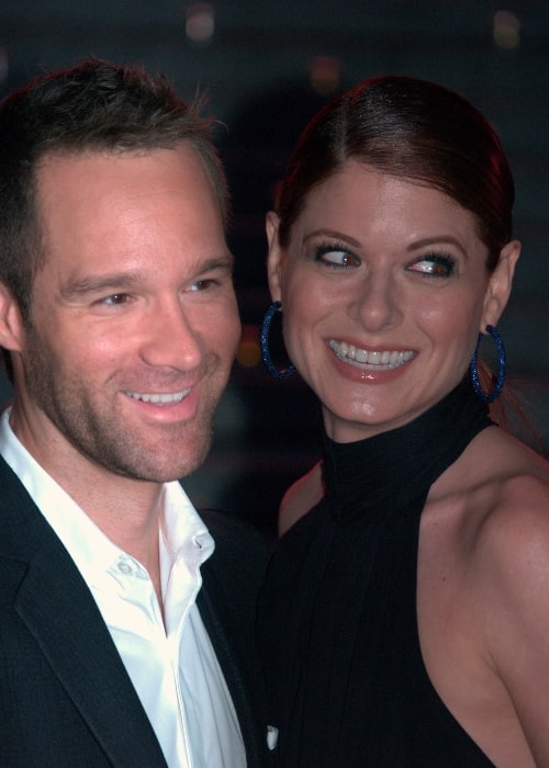 Chris Diamantopoulos smiling in a picture alongside Debra Messing at the Vanity Fair kickoff part for the 2009 Tribeca Film Festival