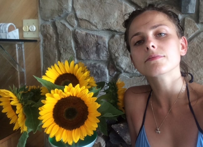 Pauline Chalamet taking a selfie with sunflowers