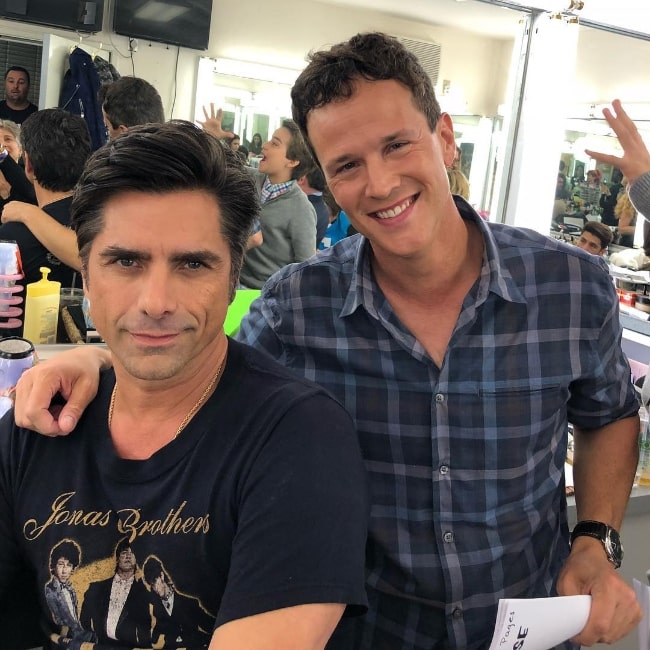 Scott Weinger (Right) smiling in a picture alongside John Stamos