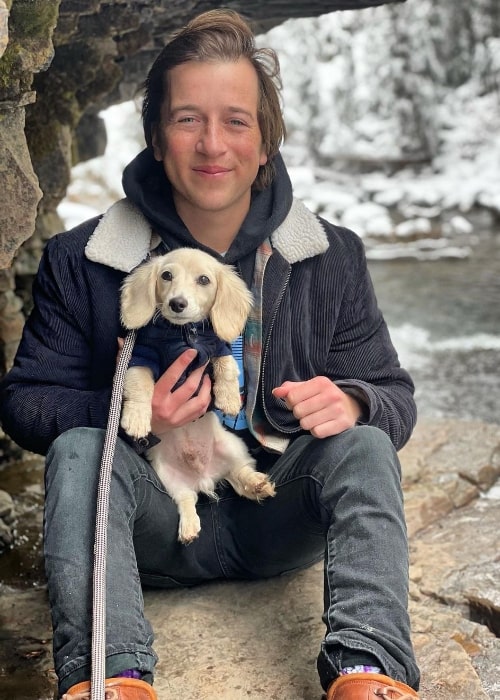 Skyler Gisondo with his dog in Big Sky, Montana in October 2021