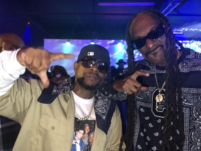 Jayo Felony (Left) as seen while posing for a picture alongside Snoop Dogg
