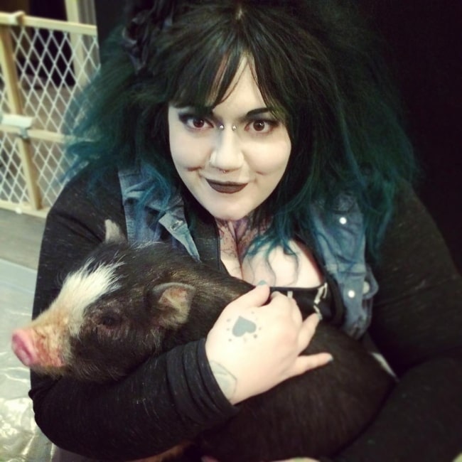 Kelly Doty in March 2017 happy to be holding a baby pig