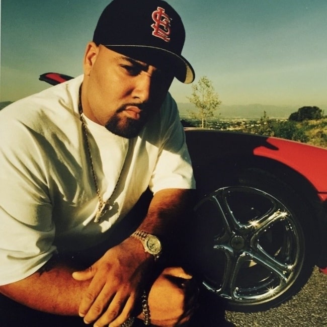 Mack 10 as seen while posing for a picture in 1996 in front of his first Ferrari