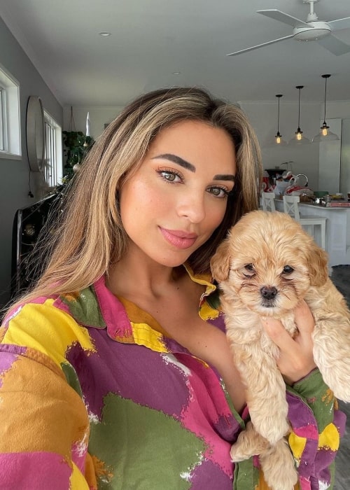 Georgia Hassarati in a selfie with her puppy Crisbo that was taken in December 2021, Australia