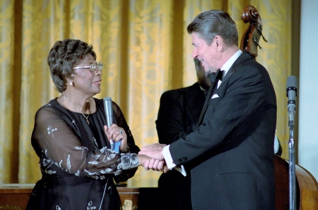 Ella Fitzgerald pictured while shaking hands with President Ronald Reagan after performing in the White House in 1981