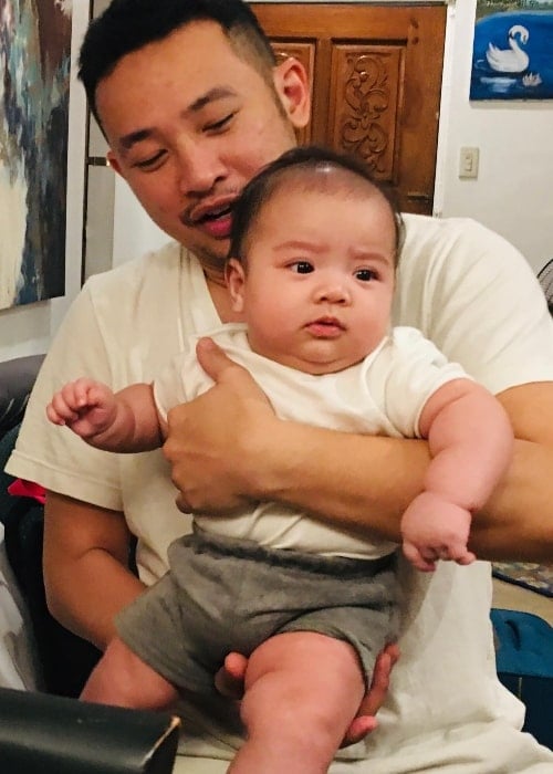 Ketchup Eusebio pictured while holding his son in 2019