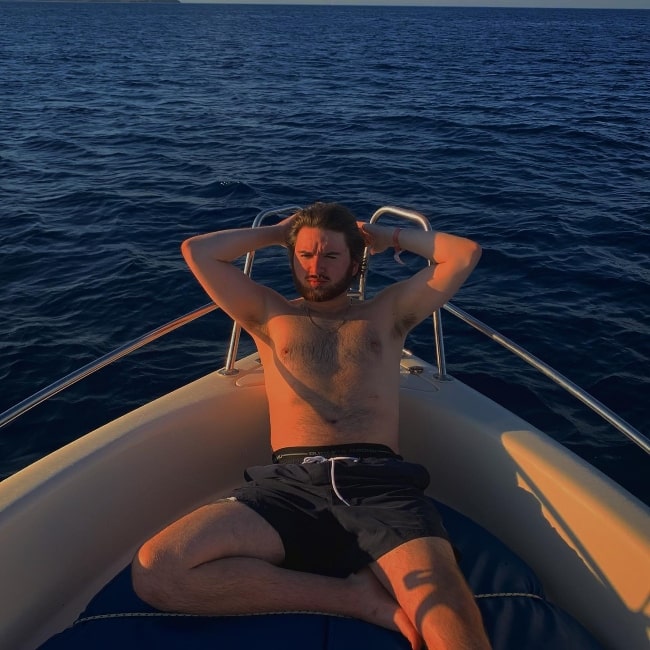 Theo Stevenson posing shirtless for the camera while enjoying his time in Lindos, Rhodes, Greece