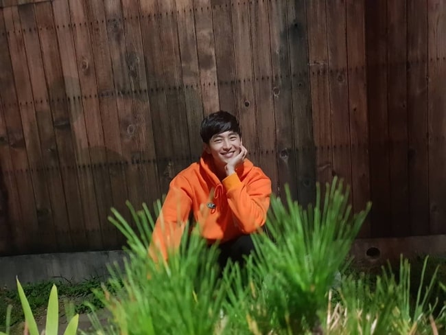 Choi Woong as seen while smiling for a picture in October 2018