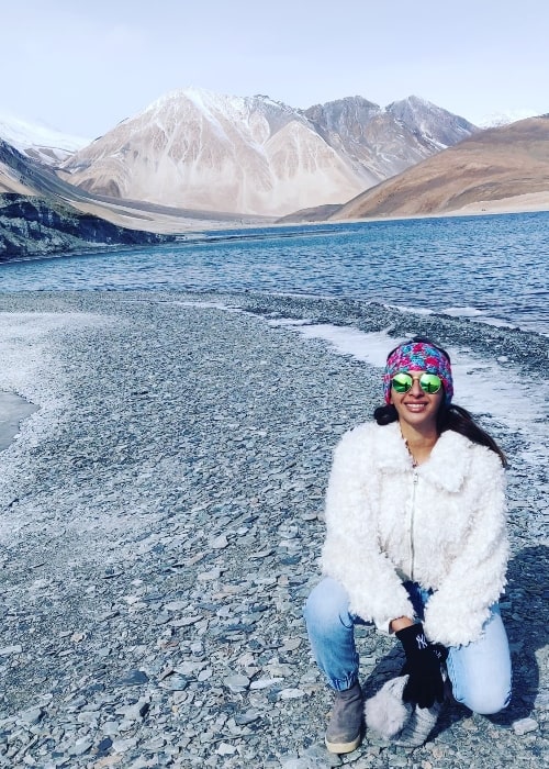 Gayathiri Iyer is seen smiling for a picture at Pangong Tso in Leh, Ladakh in January 2022