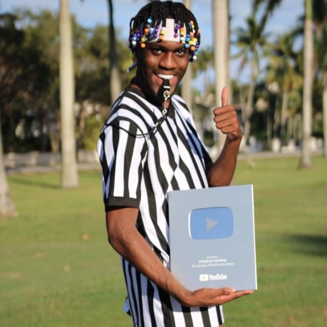 AdrianIsFunny in a picture that taken while holding his achievement plaque in February 2022, in Miami Beach, Florida