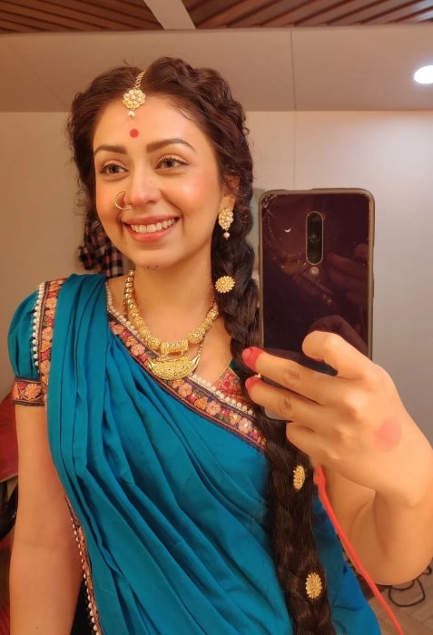 Neha Sargam as seen while smiling in a mirror selfie in June 2022