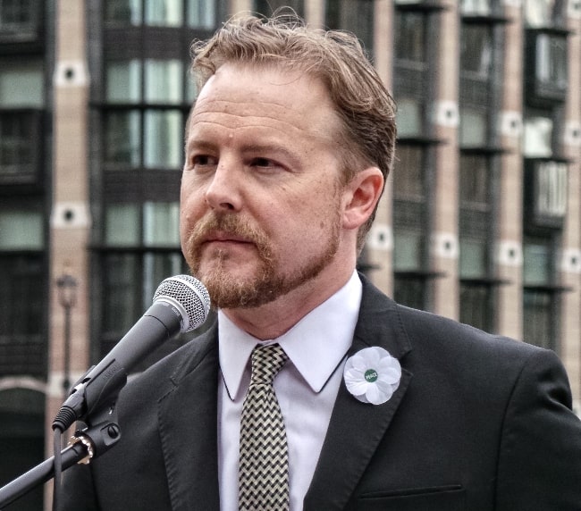 Samuel West pictured at the 'No Glory' protest in London in August 2014 wearing a Peace Pledge Union white poppy
