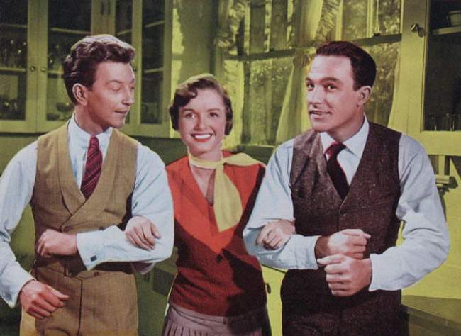 Donald O'Connor, Debbie Reynolds, and Gene Kelly seen in a lobby card for the film Singin' in the Rain