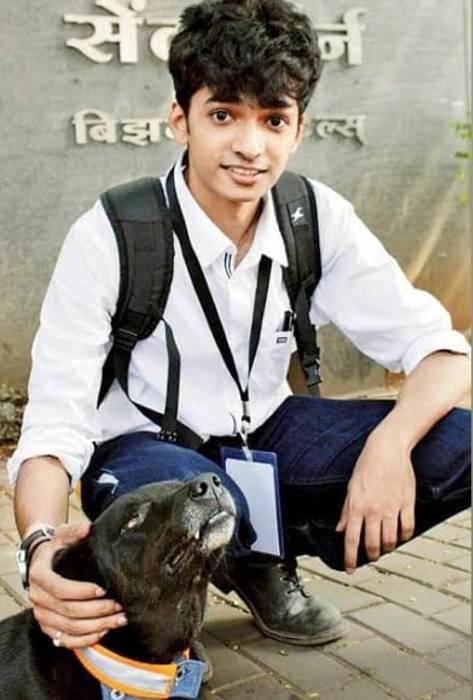 Shantanu Naidu seen posing for a picture with a stray dog