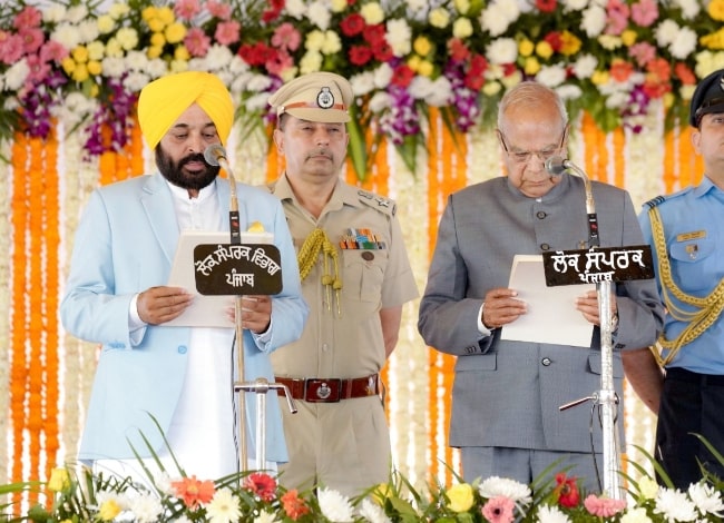 Bhagwant Mann (Corner Left) pictured while taking oath as the Chief Minister of Punjab with the oath being administered by Governor of Punjab Banwarilal Purohit in March 2022