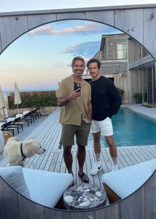 Brian Atwood seen taking a selfie with his husband Jake in 2022