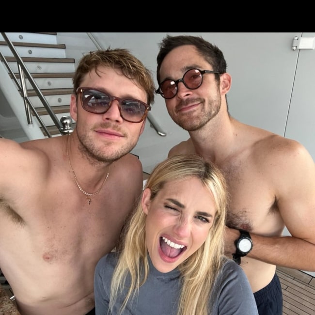 Cody John in a selfie with his beau Emma Roberts and a man named johnrtyson in August 2022