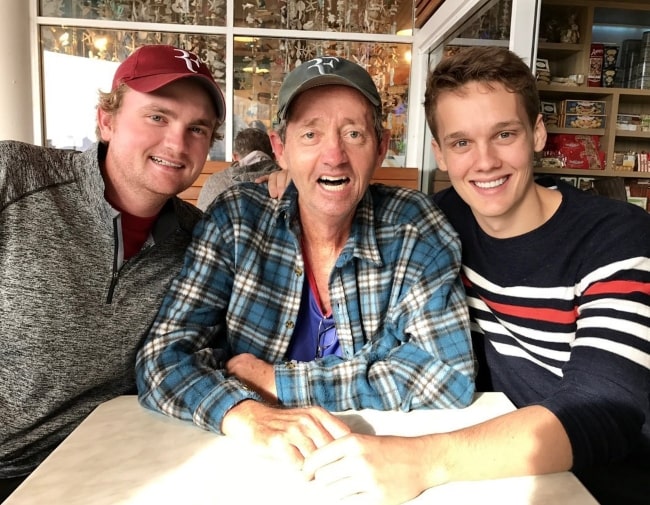 Hunter Doohan (Right) smiling for a picture with his father (Center) and brother