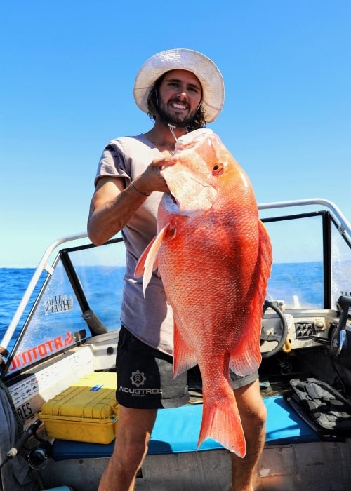 Jackson Coffey as seen in a picture that was taken with a red emperor fish in September 2022