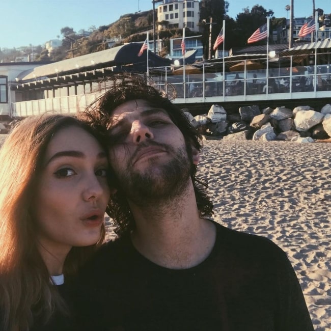 Elisa Achilli as seen in a selfie with her beau Navarone Garibaldi in August 2019, at Sunset Beach, California