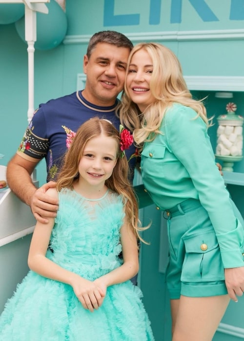 Like Nastya as seen in a picture with her father Sergey and mother Anna Radzinskaya in February 2023, in Miami, Florida