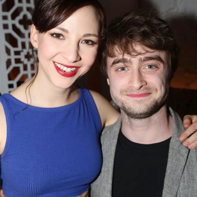 Erin Darke smiling for a picture alongside Daniel Radcliffe