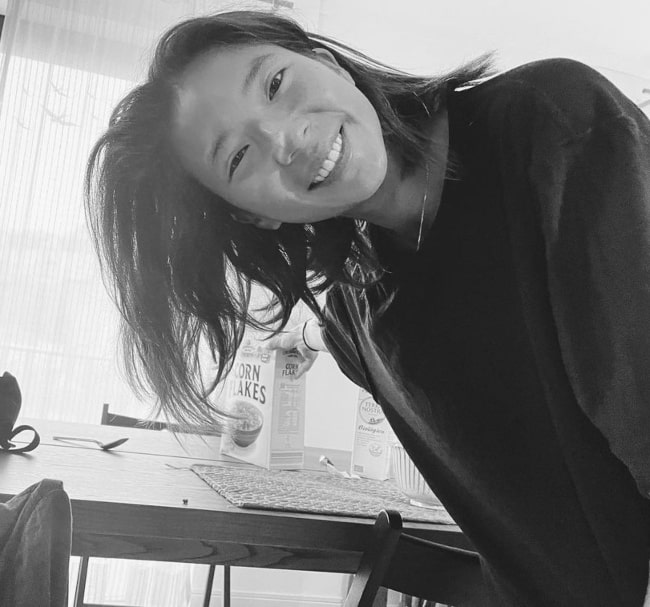 Jani Zhao as seen while smiling in a black-and-white picture in October 2022