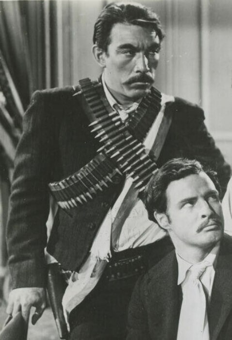 Anthony Quinn (the one who is standing) as Eufemio Zapata and Marlon Brando as Emiliano Zapata in 'Viva Zapata!' (1952)