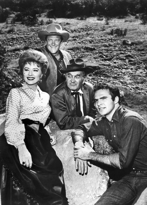 From Left to Right - Amanda Blake (as Miss Kitty), James Arness (as Matt Dillon), Milburn Stone (as Doc Adams), and Burt Reynolds (as Quint Asper) as the main cast for the television program 'Gunsmoke' in 1963