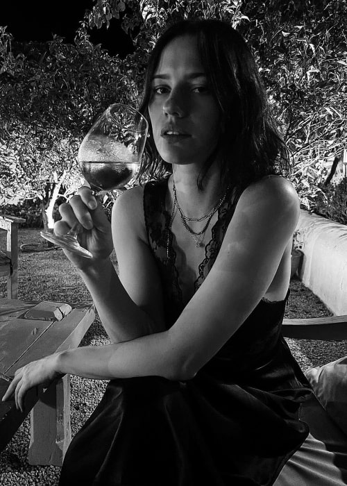 Lily Sullivan as seen in a black-and-white picture while enjoying her drink in Ibiza, Spain in July 2022
