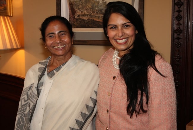 Mamata Banerjee (Left) posing for a picture with Priti Patel (then Minister of State for Employment in Government of United Kingdom and former Home Secretary of United Kingdom) in London, England in 2015