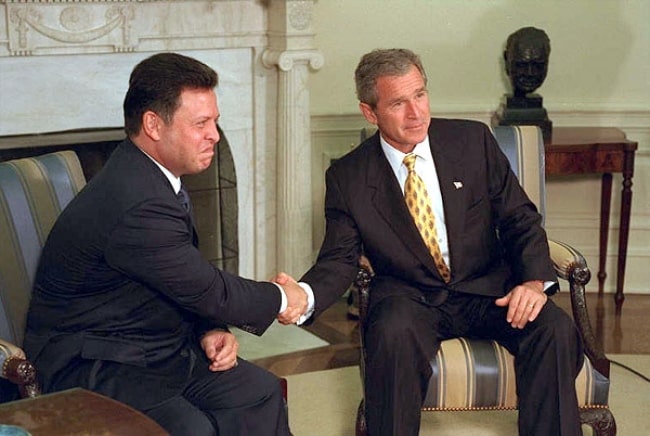 Abdullah II of Jordan (Left) and U.S. President George W. Bush posing for the camera during their meeting in the Oval Office on September 28, 2001