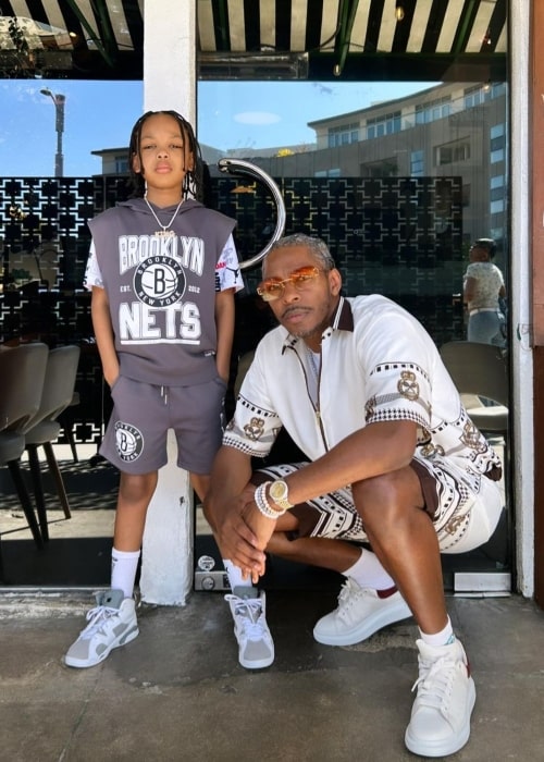 King Los as seen while posing for a picture with his son
