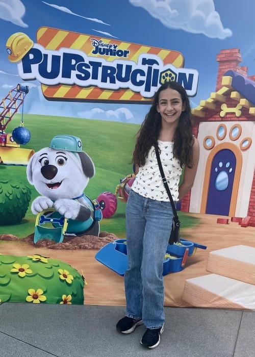 Mica Zeltzer as seen in a picture taken in front of a poster of Disney Junior's Pupstruction in June 2023