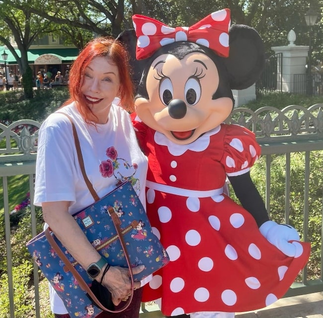 Pamela Des Barres posing with Minnie Mouse at Disney World in April 2023