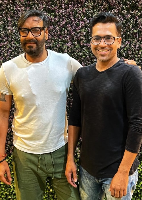 Shriidhar Dubey (Right) smiling for a picture along with Ajay Devgn in September 2022