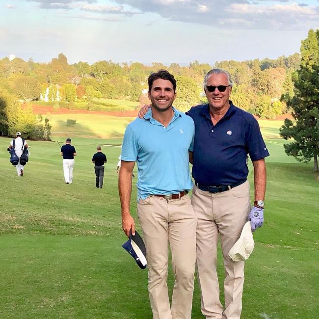 Miles Fisher (left) as seen with his friend on a golf course in March 2022