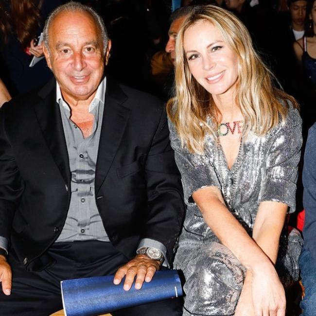 Sir Philip Green as seen smiling for a picture while sitting with Dee Ocleppo