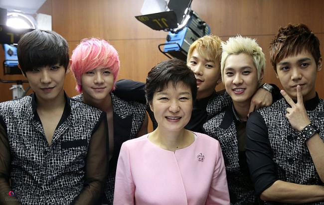 The former South Korean President Park Geun-hye as seen with members of MBLAQ in 2013
