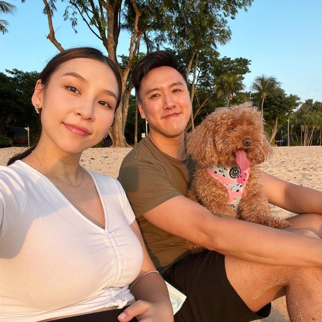 Tina Yong as seen in a picture with her husband Alfred Tran and their dog Biscuit that was taken in March 2022, in Sentosa