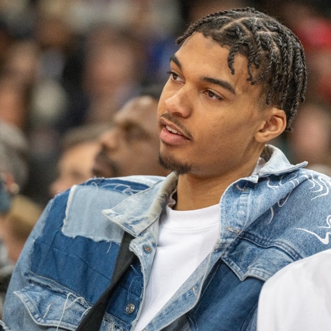 Victor Wembanyama sitting courtside at an NBA game in Paris, France in 2023