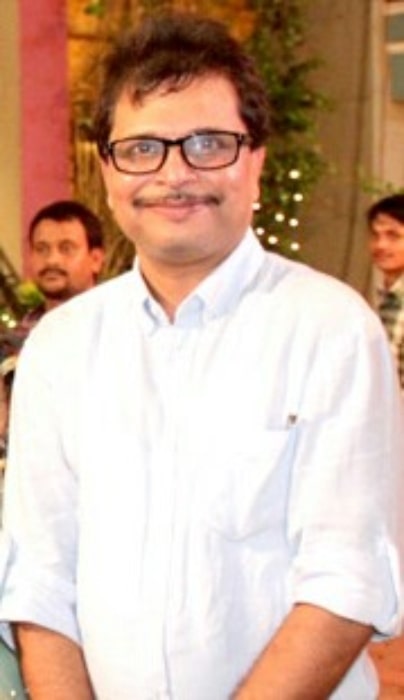 Asit Kumarr Modi as seen while smiling for the camera in 2013