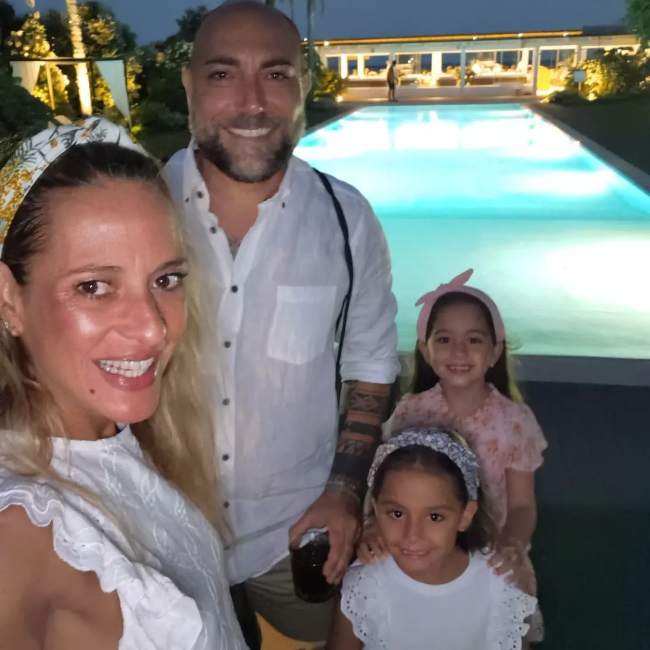 Christa Rigozzi as seen in an Instagram selfie with her husband and daughters in July 2023