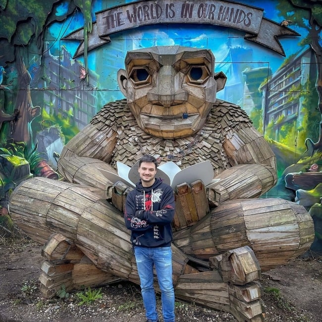 Felipe Neto as seen in a picture taken in May 2023, in front of one of Danish artist Thomas Dambo's Troll hunt masterpieces in Denmark