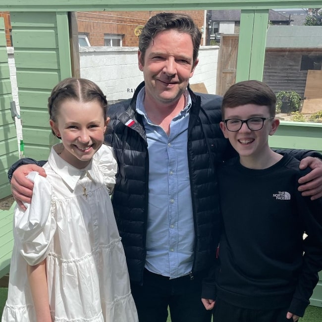 Katelyn Rose Downey as seen in a picture with film and TV director Ronan Burke and actor and magician Aidan McCann while on the set of Clean Sweep, in May 2023