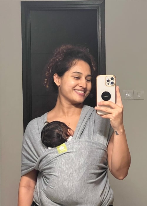 Pooja Ramachandran as seen while taking a mirror selfie with her baby in June 2023