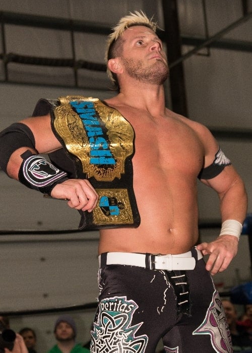Alex Shelley as seen while posing with the Smash Wrestling Championship belt at their Challenge Accepted show in 2014