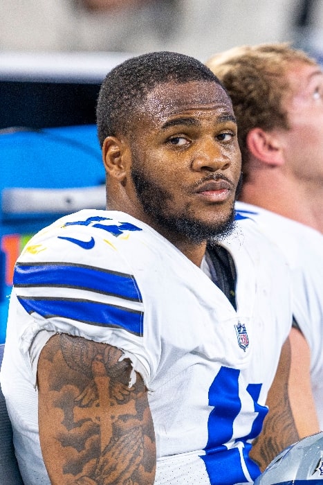 Micah Parsons playing for the Dallas Cowboys in a game against the Washington Football Team at AT&T Stadium on December 26, 2021