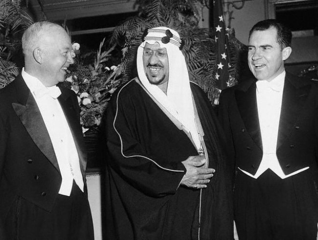 President Dwight D. Eisenhower (Left) and Vice President Richard Nixon (Right) with their host, King Saud of Saudi Arabia (Center), attending the dinner given by the King at the Mayflower Hotel in 1957